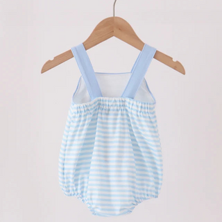 A baby romper with light blue and white horizontal stripes, featuring light blue shoulder straps and a white mesh chest panel, hanging on a wooden hanger from a wooden clothes rack against a plain light background.