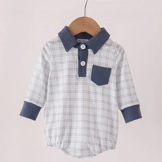 A baby long-sleeve polo romper with a light blue and white plaid pattern, featuring solid navy blue collar, cuffs, and chest pocket, hanging on a wooden hanger.