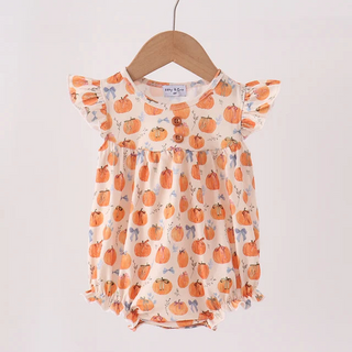 A baby romper with a pumpkin print hanging on a wooden hanger from a light wood clothing rack against a plain white background.