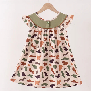 A toddler girl's sleeveless dress with a smocked bodice, ruffled cap sleeves, and an abstract organic print in earthy tones. The dress features a solid olive green collar with a small button detail and hangs on a wooden hanger against a clean white background.