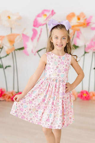 Young girl wearing a floral dress with a colorful background