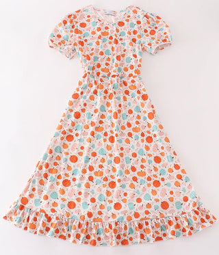 An orange pumpkin print women's dress with a floral pattern, displayed on a mannequin.