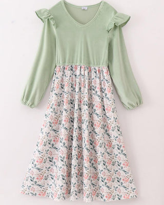 An adult dress with a floral print on a green velvet background, featuring a round neckline and three-quarter sleeves.