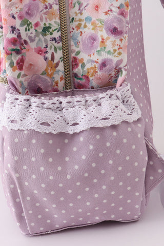 Floral-patterned fabric with lace trim on a polka dot background