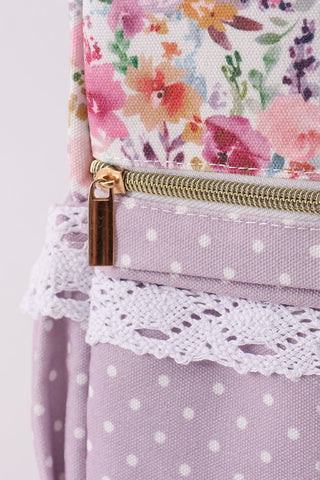 Floral fabric with a gold zipper on a light purple background