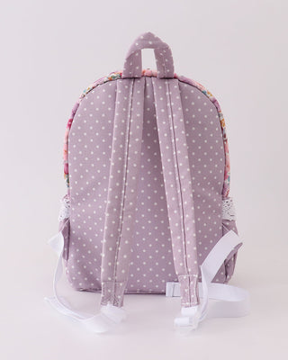 Backpack with polka dot pattern on a light gray background