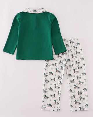 Green top and duck-patterned pants on a white background