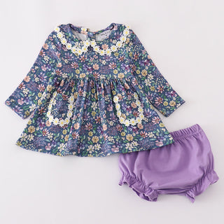 Floral dress with long sleeves and purple bloomers on a white background