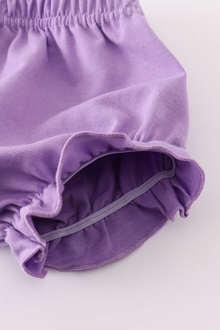 Purple baby bloomers on a white background
