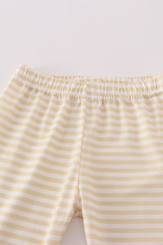 Yellow and white striped pants on a light gray background