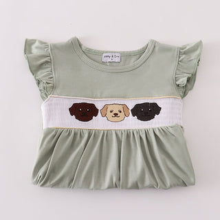 Green top with dog-themed design on a white background