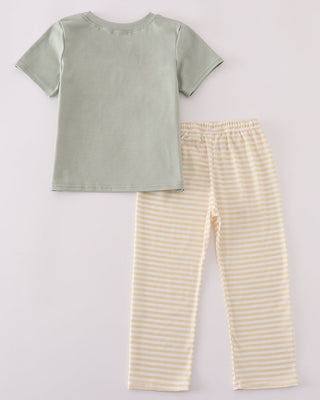 Green t-shirt and yellow striped pants on a light gray background