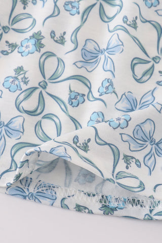 Fabric with blue bows and floral patterns on a white background