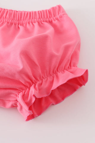 Pink baby bloomers on a light gray background