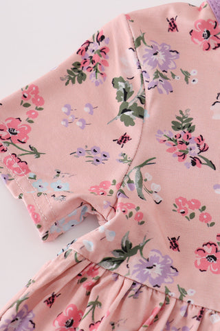 Pink floral dress with a close-up of the fabric texture on a light background