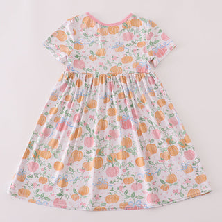 Floral dress with pumpkins on a plain background