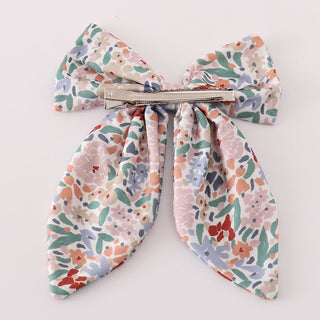 Floral hair clip  with a bow on a white background