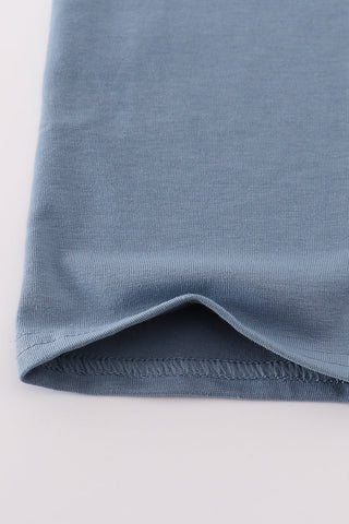 Close-up of a blue fabric edge on a light gray background