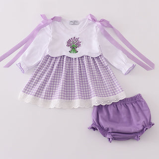 Baby outfit with checkered dress, white shirt, and purple bloomers on a light gray background