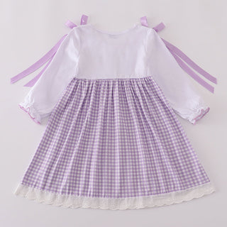 Purple checkered dress with white sleeves on a light gray background