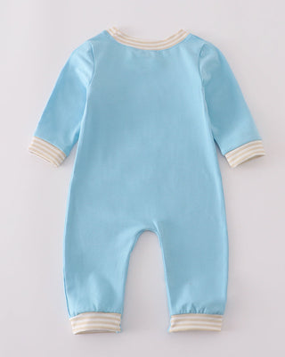 Light blue baby onesie with white trim on a light gray background