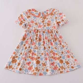 Floral smocked dress with a white background