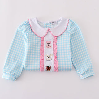 Children's checkered shirt with a collar and pink trim on a light gray background