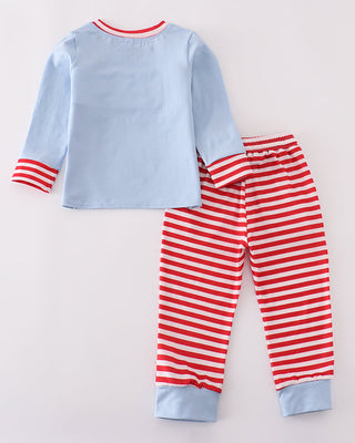 Children's outfit set with blue top and red striped pants on a light gray background
