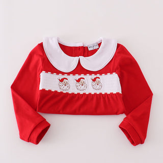 Red folded top with white collar and embroidered details on a light gray background