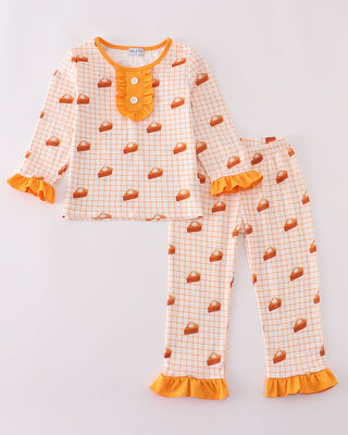Children's pajama set with orange and brown pattern on a light gray background
