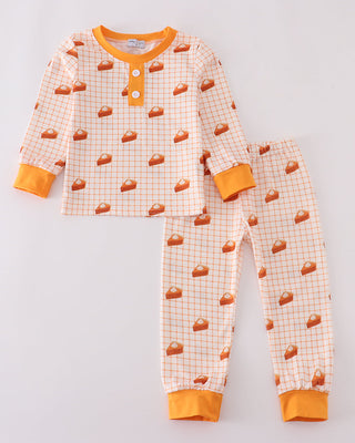 Children's pajama set with pie pattern on a light gray background