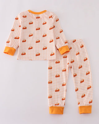 Children's pajama set with pie pattern on a light gray background
