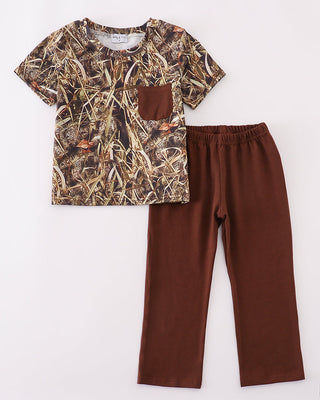 Camouflage shirt and brown pants on a white background