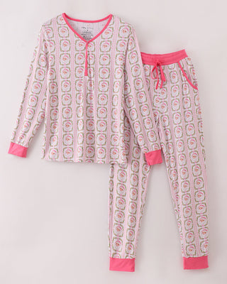 Women’s pajama set with pink and white pattern on a light gray background