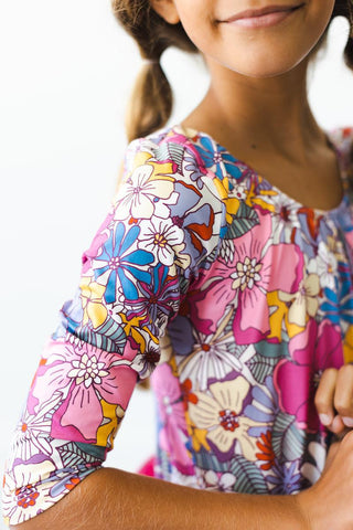 Close-up of a colorful floral-patterned leotard worn by a person.