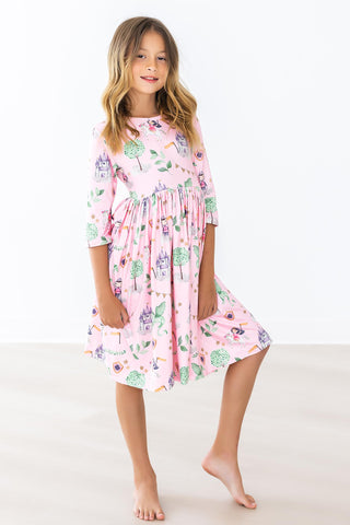 Young girl wearing a pink floral dress on a white background