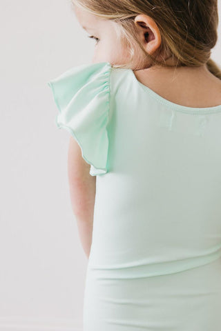 Mint green leotard with ruffled sleeves worn by a child on a light background
