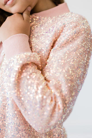 Close-up of a glittery peach jacket with a blurred background