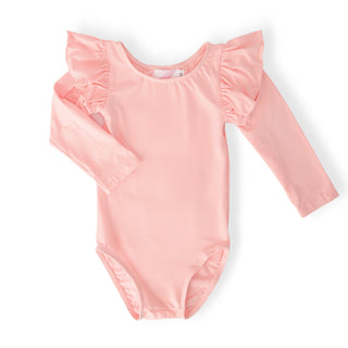 Pink leotard with ruffled sleeves on a white background