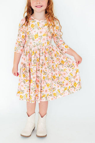 Young girl wearing a floral dress with white boots on a white background