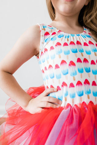 Child wearing a colorful leotard with ice cream pattern