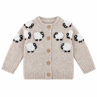 A beige knit cardigan sweater for babies, featuring a pattern of white sheep with black faces and bodies across the chest and shoulders, and four wooden buttons down the front.