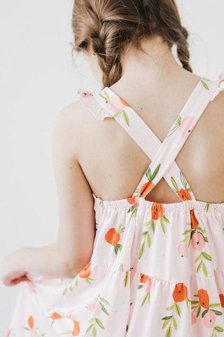 Back view of a person wearing a floral dress with a white background