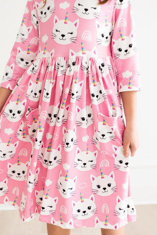 Pink dress with cat unicorn pattern worn by a person