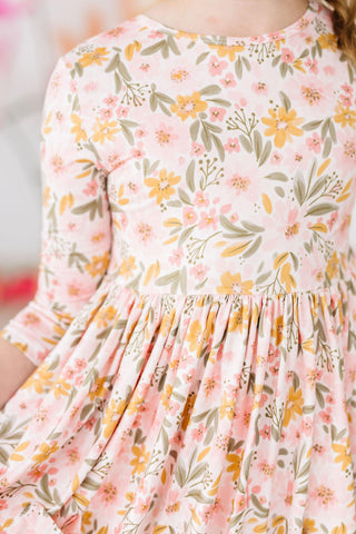Floral dress with pink, yellow, and green pattern on a blurred background