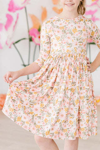 Young girl wearing a floral dress against a floral background