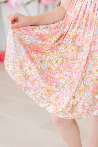 Floral dress with pink and gold flowers on a blurred background